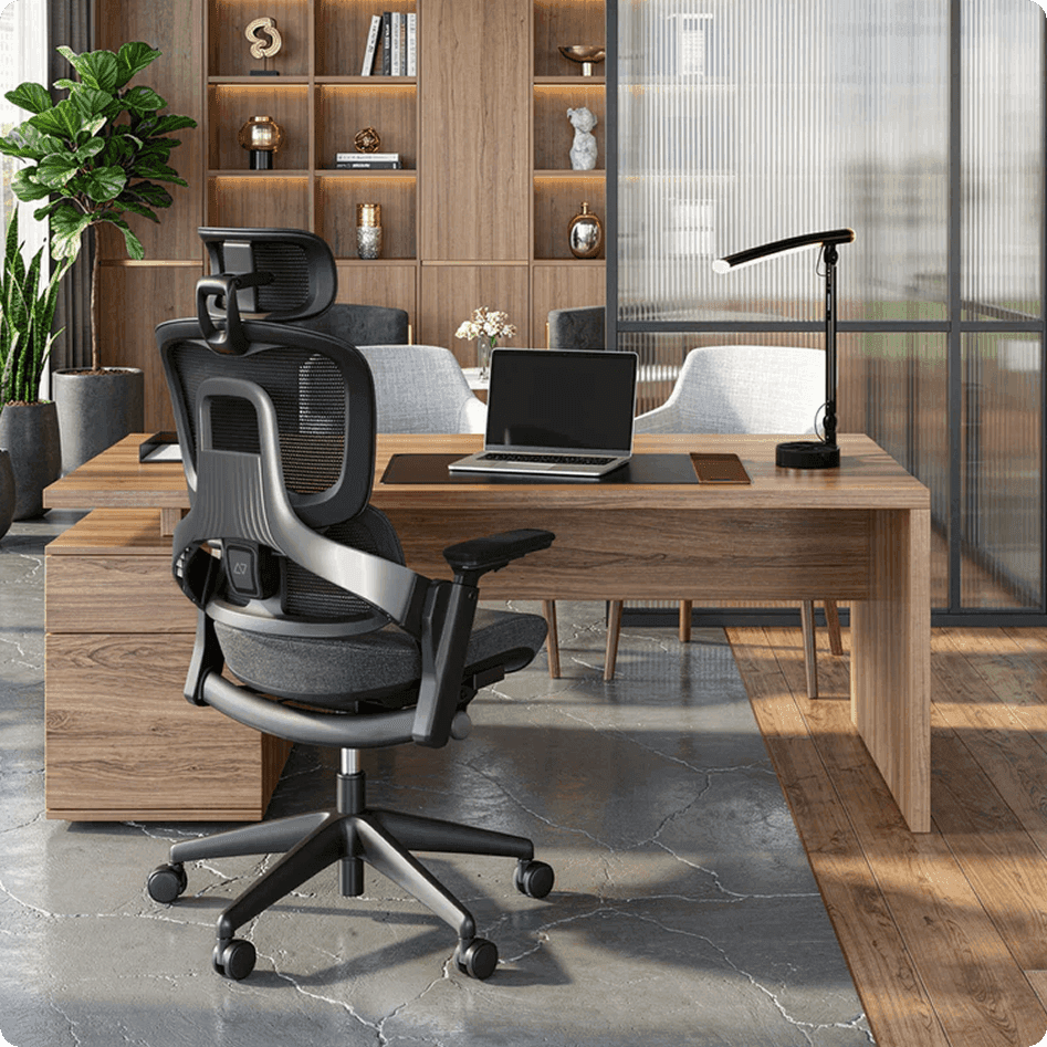 Black ergonomic office chair in a modern office with a wooden desk and laptop.