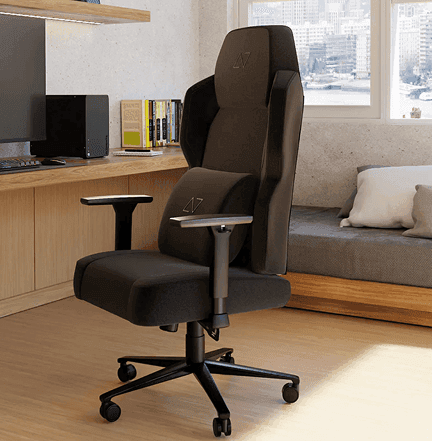 A black ergonomic gaming chair with lumbar support in a modern home office setup.